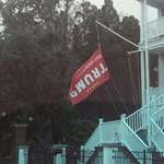 image for Saw this on the way to work. Trump flag hanging upside down, a symbol for distress [OC]