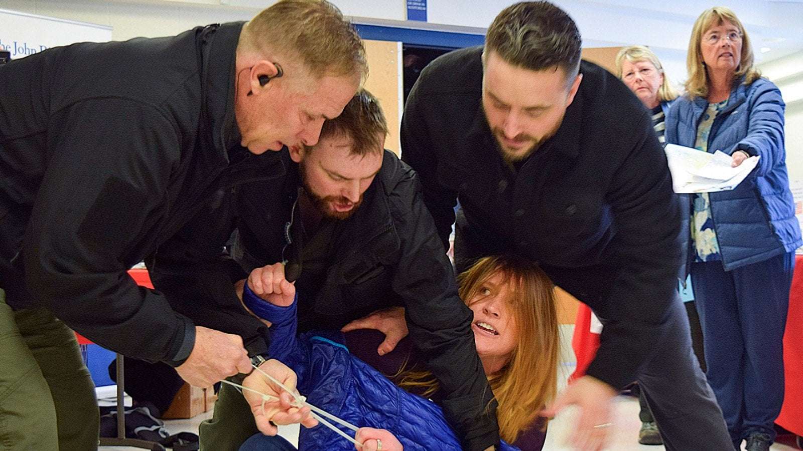 image for Woman Dragged From Republican Town Hall Seeks $5 Million In Damages