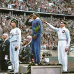 image for Jesse Owens USA salutes after defeating Nazi Germany’s Lutz Long in long jump, 1936 Berlin Olympics.