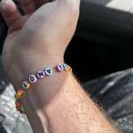 image for [OC]My daughter made my wife and I friendship bracelets, my wifes says mom❤️, mine says to nate