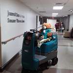 image for Teddy Bear driving automatic cleaning machine, working at night in a hospital.