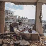 image for 8 years ago today, u/olizardo posted this image of a family in Gaza, "You can't destroy a parent"