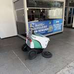 image for A self driving delivery robot broken down in downtown LA