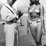 image for A police officer ticketing a woman for wearing a bikini on an Italian beach, 1957