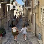 image for My daughters walking to the piazza in Lucca Sicula
