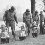 image for Dutch girls escorting American soldiers to a dance (after ww2)
