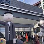 image for Protesters at the Tesla diner and there's Inflatable Elon Musk outside the Tesla diner in Hollywood