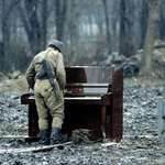 image for In 1994, a Russian soldier was photographed playing an abandoned piano in Chechnya.