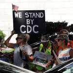 image for [OC] A protester holds a "WE STAND BY CDC" sign at Atlanta's "Sound Science Saves Lives" Protest