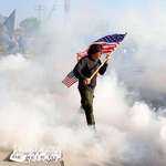 image for Curtis Evans, vet, carries flag through gas by federal officers ICE facility Broadview, IL 9/19/25