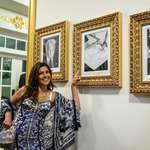 image for Secretary of Transportation's wife pointing at the image of Joe Biden's portrait