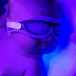 image for My newborn son under a light therapy machine that helps treat Jaundice.