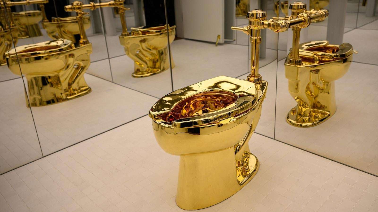 image for Solid gold toilet named 'America' sells at auction for $12M