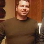 image for Jonathon Ross wearing a brown shirt