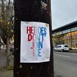 image for A piece of paper stapled to a telephone pole next to the street.