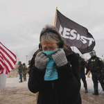 image for Woman covers her face from tear gas in Minneapolis (AP News/Adam Gray)