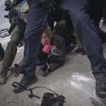image for Photographer John Abernathy throws his camera to another photographer to prevent ICE from taking it