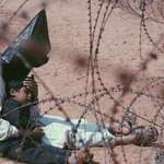 image for Iraqi prisoner of war comforting his 4 year son in Najaf, Iraq (2003)