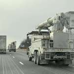 image for Convoy of Canadian linesmen heading south yesterday to help repair storm damage in the U.S.