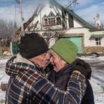 image for Couple comfort each other outside their home after damage from a Russian bombing raid in Donetsk
