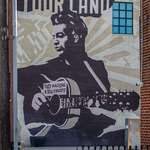 image for "This Machine Kills Fascists"  -- Mural on Woody Guthrie Center in downtown Tulsa [OC]