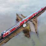 image for A regional train passes a railroad crossing between flooded fields in Nidderau-Eichen, Frankfurt
