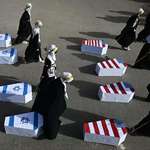 image for Muslim women drag coffins wrapped during a rally to mark Al-Quds Day
