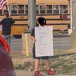 image for 10 Year Old with Controversial Sign Protesting with Family.