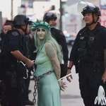 image for LAPD officers arrest a protester dressed as the Statue of Liberty during No Kings protest
