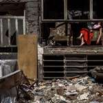 image for A woman amidst the ruins of her home in Tehran
