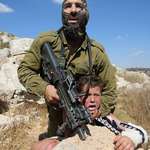 image for August 28, 2015, An Israeli soldier attempting to arrest 12 year old Mohammad Tamimi with broken arm