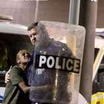 image for Australian cop comforting a grieving Aboriginal woman during riots at Alice Springs Hospital