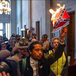 image for Tennessee State Rep Justin Jones burns a print out of the confederate flag in the state capitol