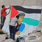 image for Palestinian artists painting a mural of Lamine Yamal on the rubble in Gaza City.