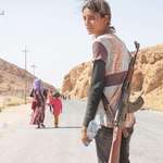 image for Yazidi girl fleeing combat zone in northern Iraq , 2014