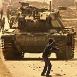 image for 15-year old Faris Odeh throwing a rock at an IDF tank in Gaza during the Second Intifada