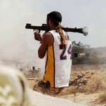 image for A Libyan soldier launches an RPG , wearing a Kobe Bryant jersey