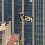 image for Protesters climb the Empire State Building and display a flag
