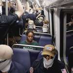 image for Members of Patriot Front ride the metro as a commuter looks on, REUTERS/Cheney Orr