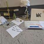 image for My coworkers created a shrine to a dead cockroach in the hallway this morning